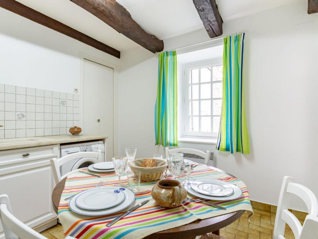 a kitchen with a table with plates on it at Holiday Home La Vallée by Interhome in Cancale