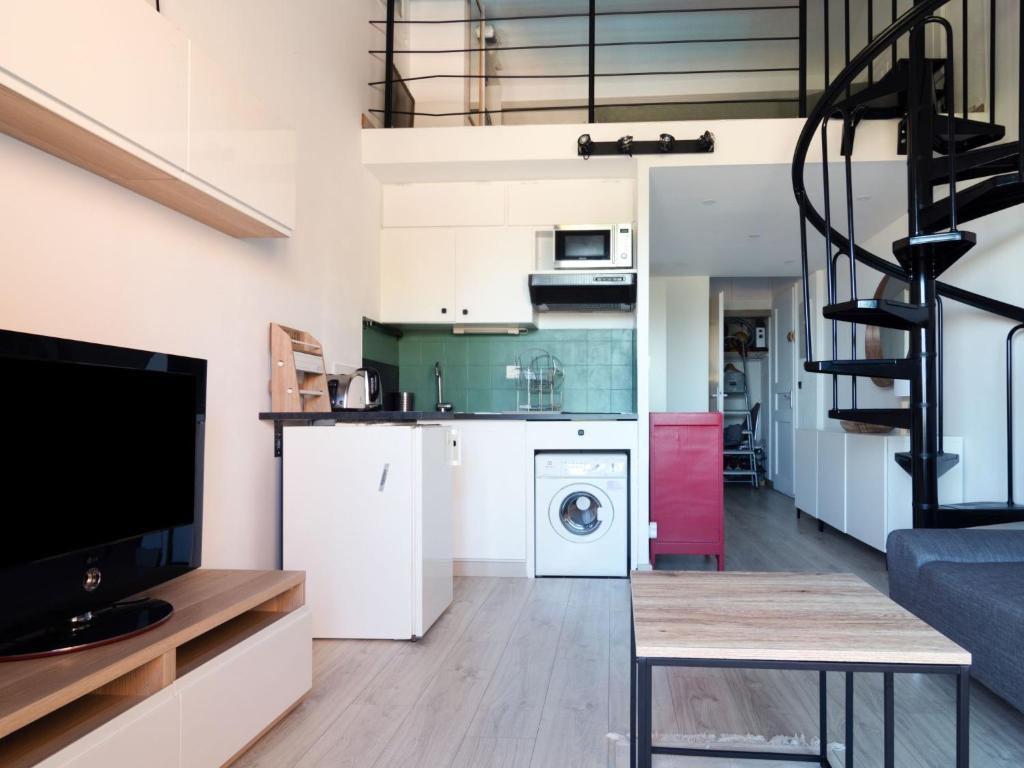a kitchen and a living room with a staircase at Apartment Les Jardins d&#39;Amaryllis-8 in Cavalaire-sur-Mer