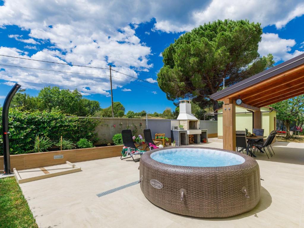 a backyard with a hot tub and a patio at Holiday Home Laura in Pula
