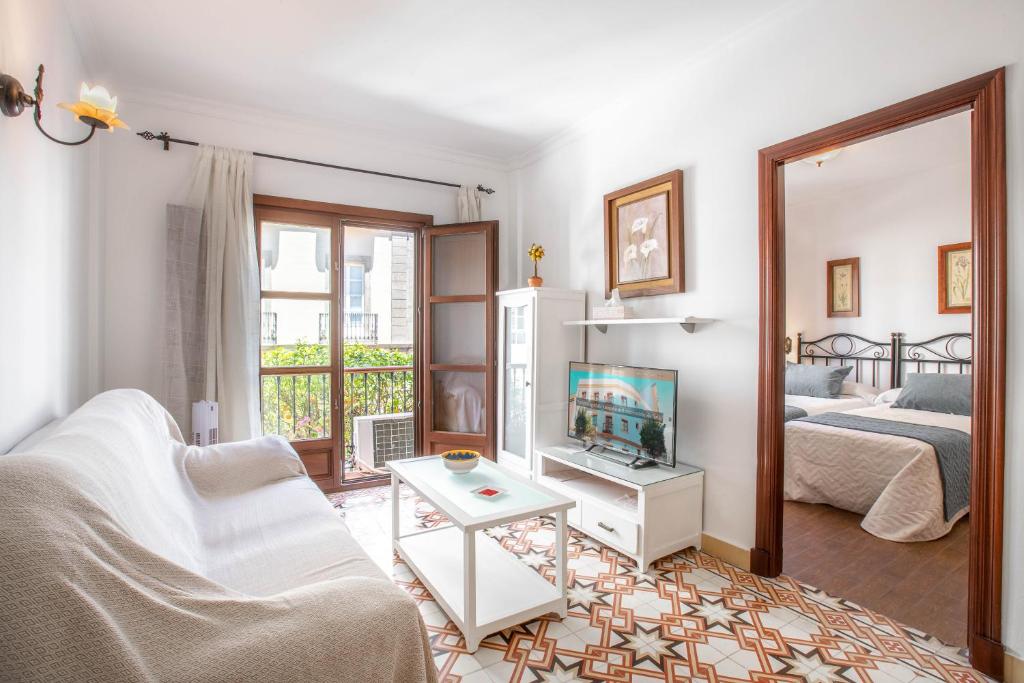 a living room with a couch and a tv at Apartamentos Trujillo in Tarifa
