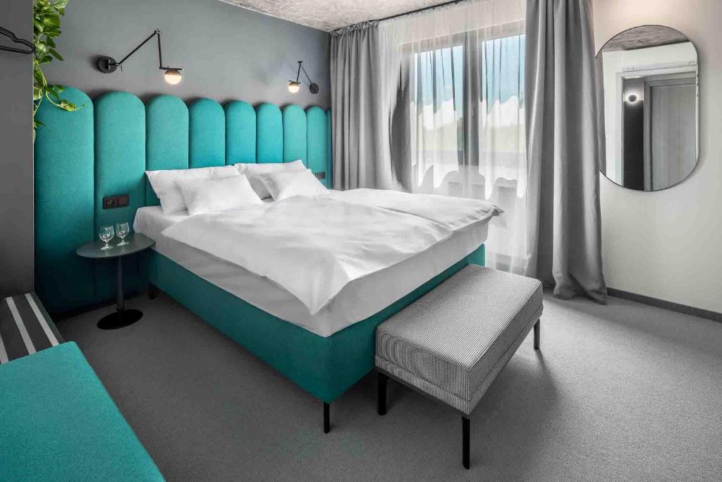 Postel nebo postele na pokoji v ubytování Boutique Hotel Mezi švy