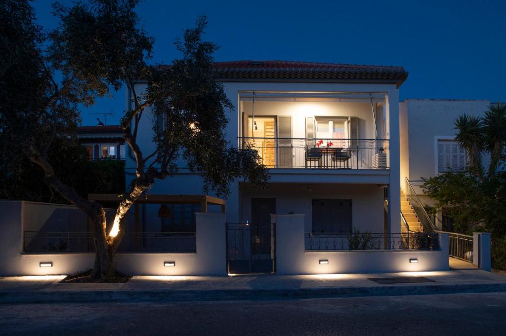 a white house with a tree in front of it at VICANTI Luxury Apartments in Pylos