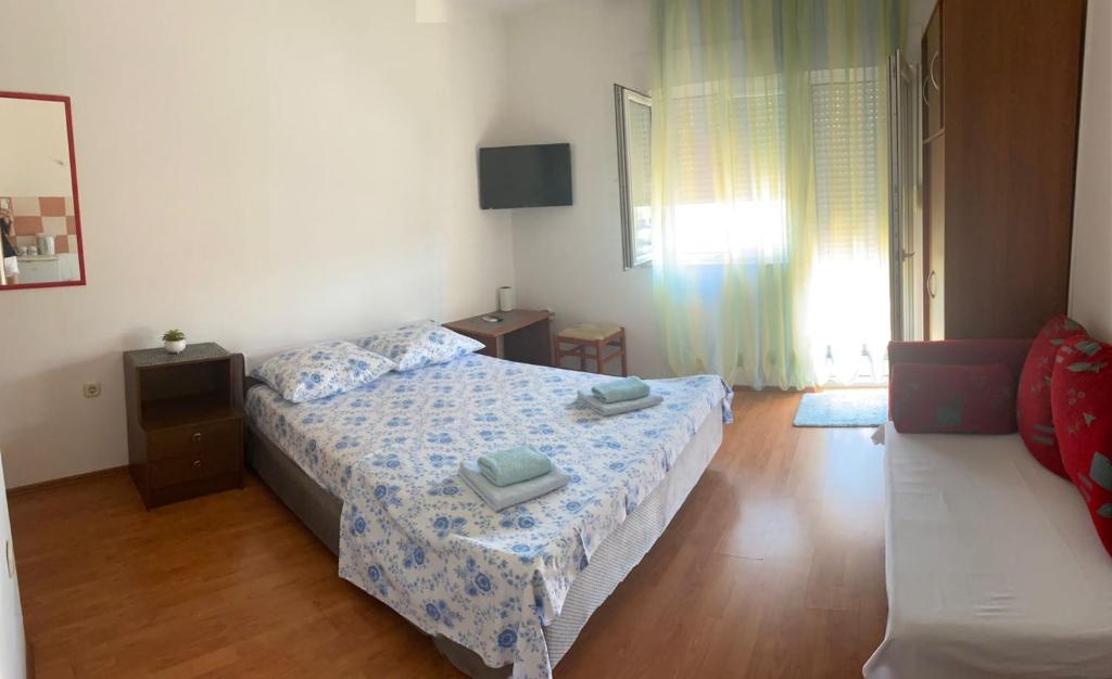Postel nebo postele na pokoji v ubytování Apartmani Udovicic