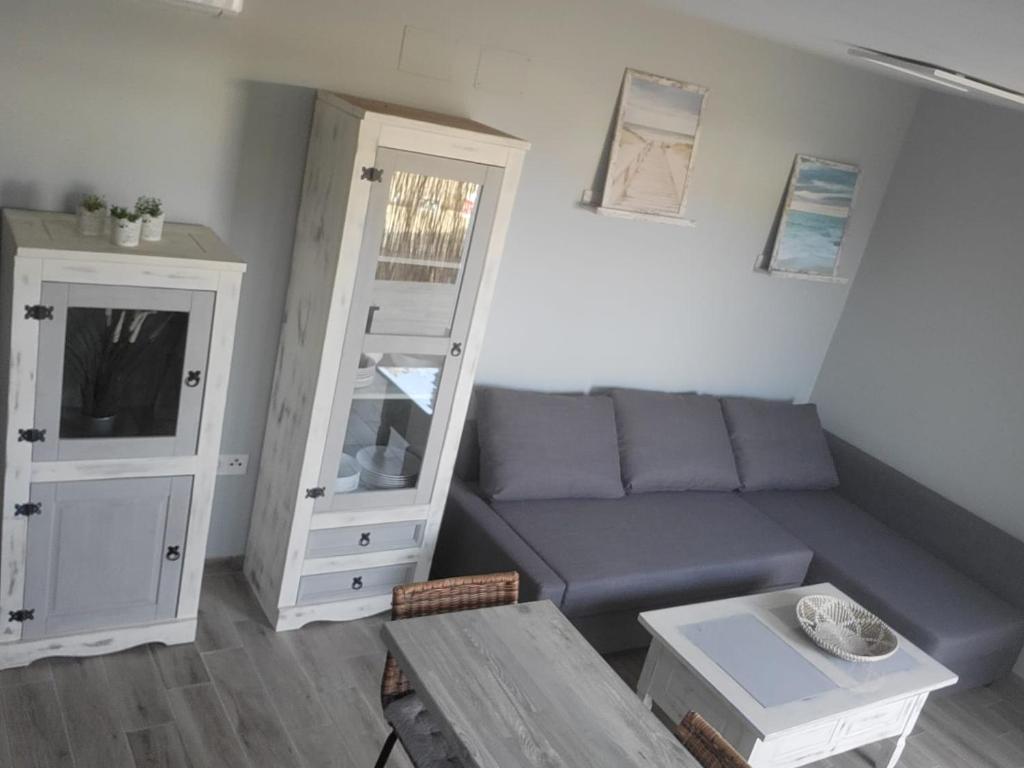 ein Wohnzimmer mit einem Sofa und einem Tisch in der Unterkunft ZARAPITO in Chiclana de la Frontera