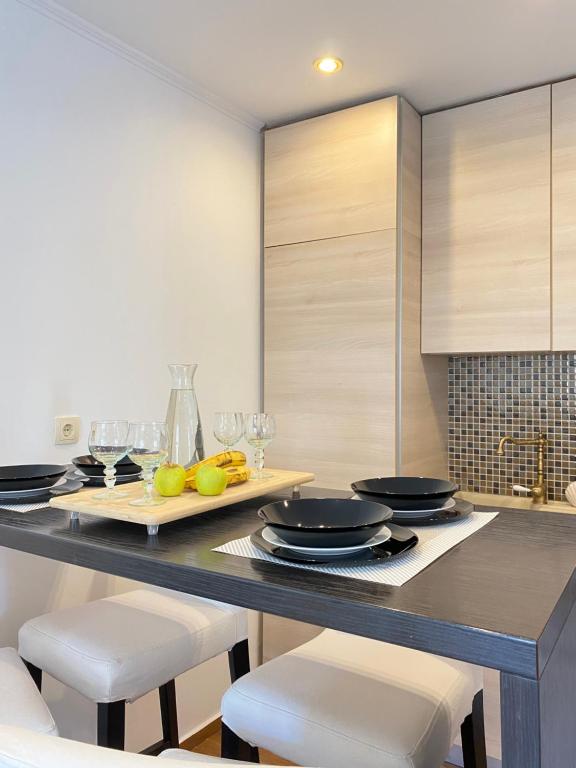 a kitchen with a table with plates and glasses at Tower House Vodice in Vodice