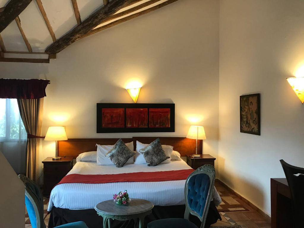 a bedroom with a bed with two pillows on it at Hotel Santa Viviana Villa de Leyva in Villa de Leyva