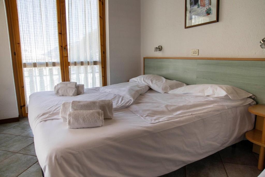 Postel nebo postele na pokoji v ubytování Residence Nube D'Argento