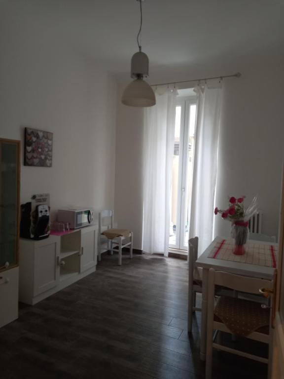 a living room with a table and a window at DormireInCentro in Ancona