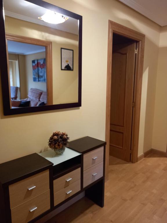 a bathroom with a dresser and a mirror at Apartamento Sopuente in Selaya