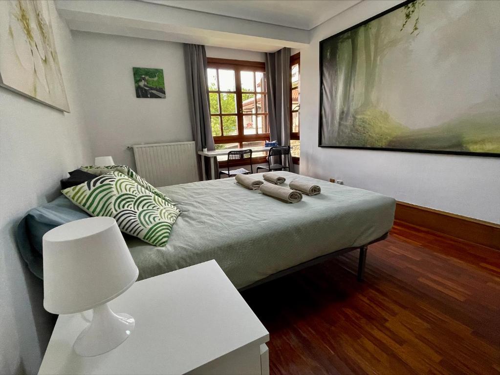 a bedroom with a bed with a large painting on the wall at Casa Koski LSS00259 in San Sebastián