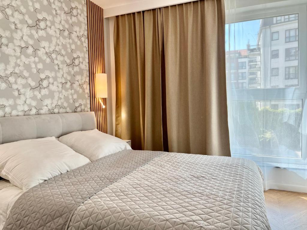 Postel nebo postele na pokoji v ubytování Apartamenty Angielska Grobla Q4Apartments