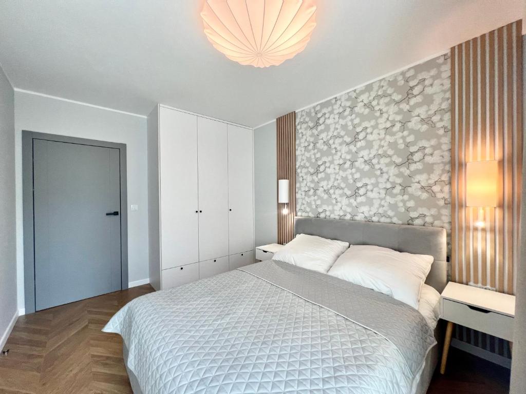 Postel nebo postele na pokoji v ubytování Apartamenty Angielska Grobla Q4Apartments