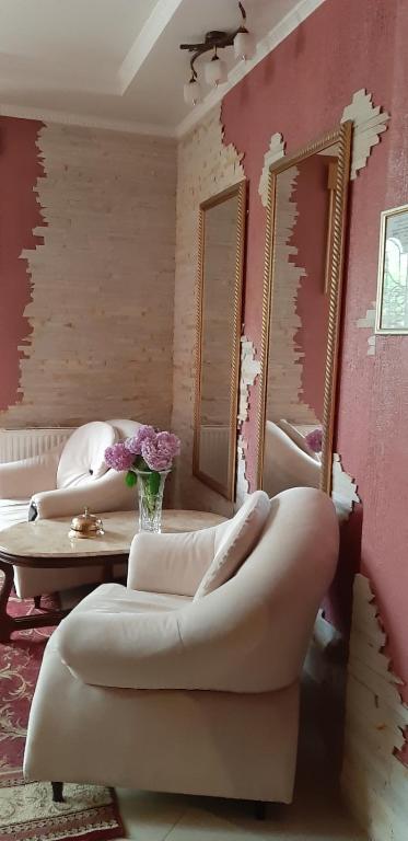 a room with two mirrors and a couch and a table at Готель Преміум in Lviv