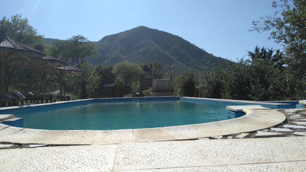 a swimming pool with a mountain in the background at Hotel Bates in Villa General Belgrano