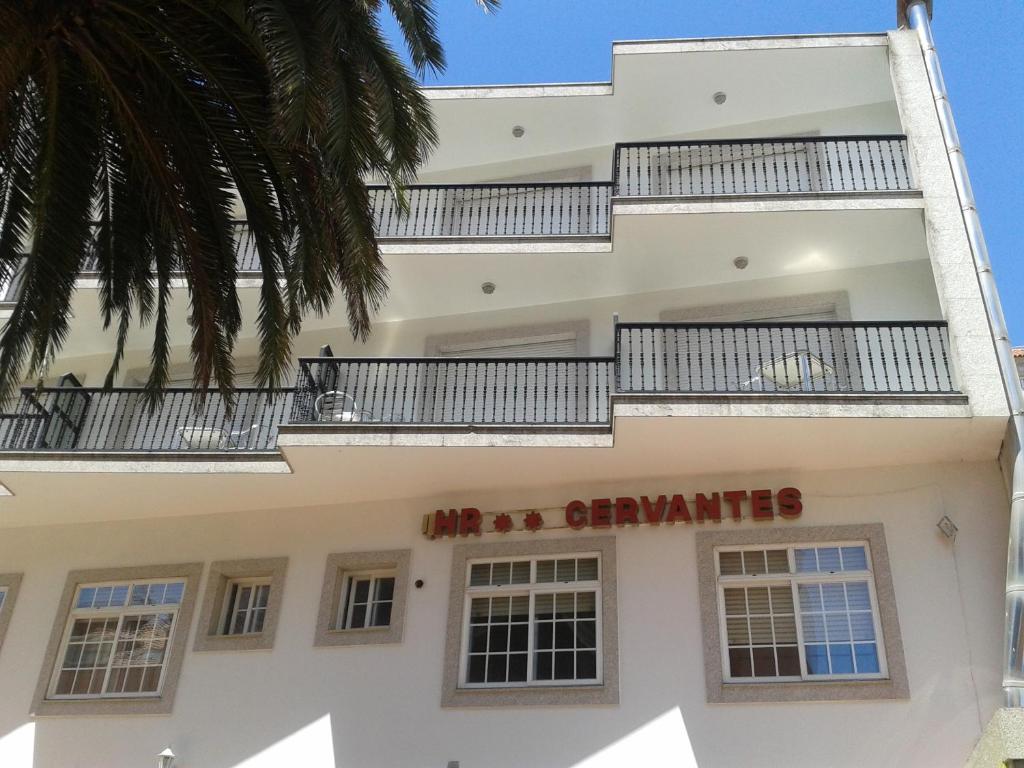 a building with a sign that reads the apartments at Hotel Cervantes in Sanxenxo