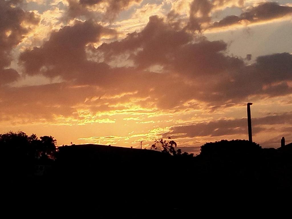 a sunset with clouds in the sky at Casa Chao in Estopiñán