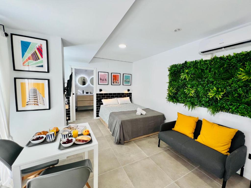 a bedroom with a bed and a table and chairs at COOL LOFTS ALAMEDA VALENCIA in Valencia