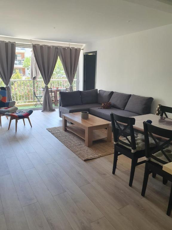 un salon avec un canapé bleu et une table basse dans l'établissement Cavalaire Sur Mer, à Cavalaire-sur-Mer