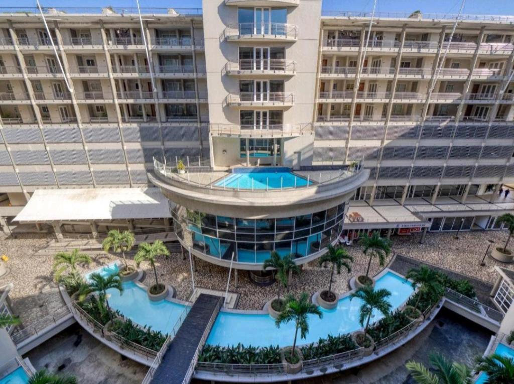 an aerial view of a building with a swimming pool at Lovely 2 Bedroom 2 Bathroom Seaview Apartment C409 in Durban