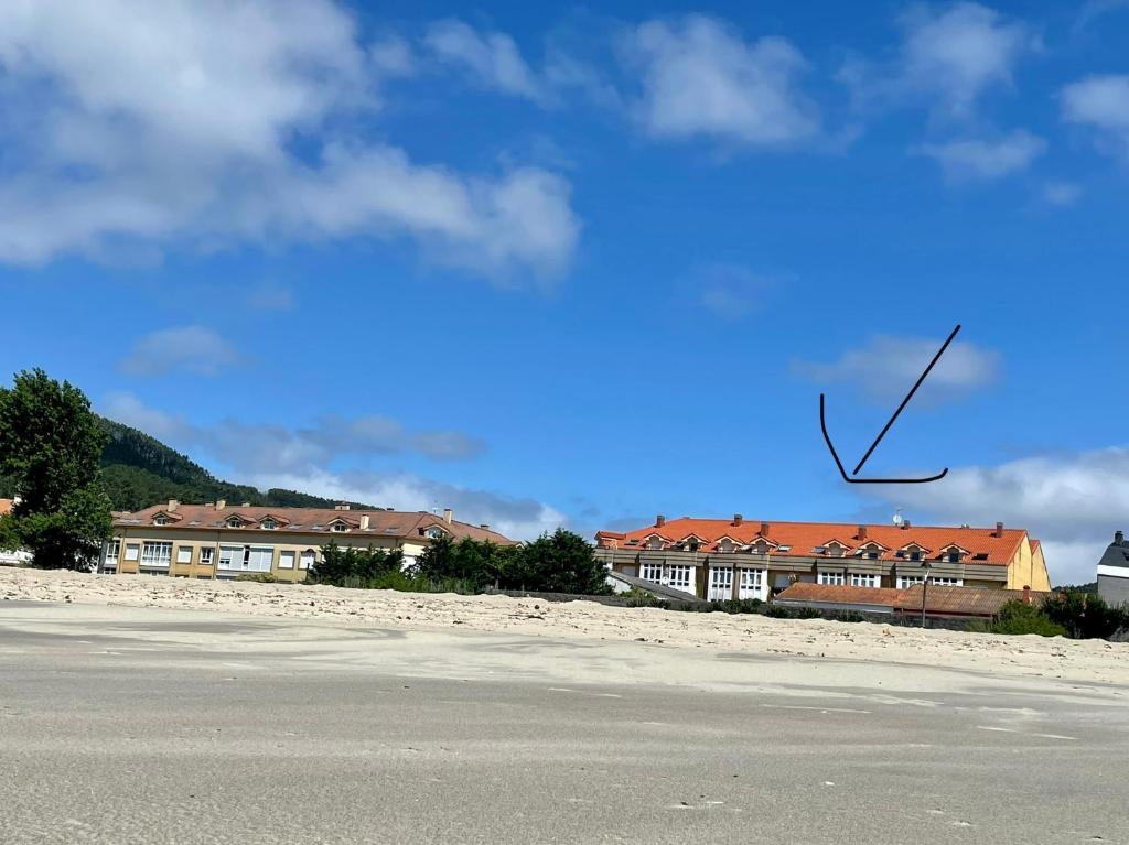 a picture of a house with a x in the sky at Casa da PRAIA in Fisterra