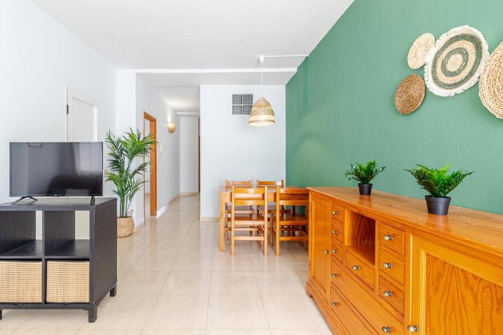 a living room with a kitchen and a dining room at Flatguest Fuerteventura Airport in Puerto del Rosario