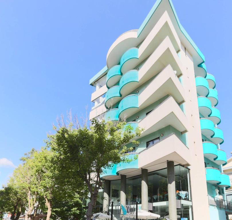 a building with balconies on the side of it at Hotel Ali d'Oro in Rimini