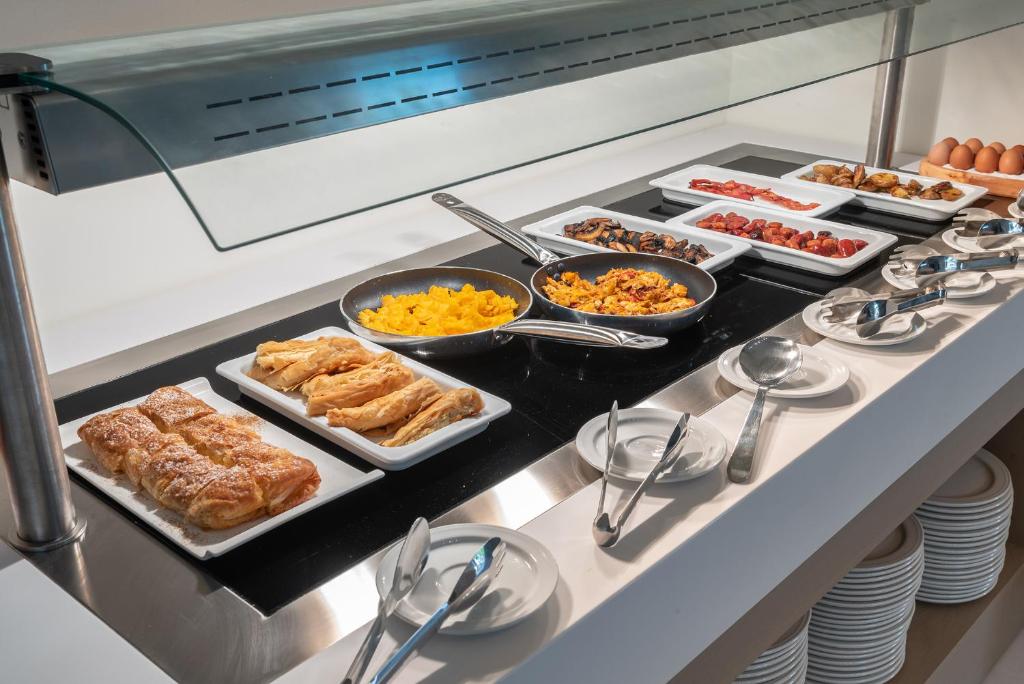 a buffet with many different types of food on it at GRAND PATELLI in Myrina