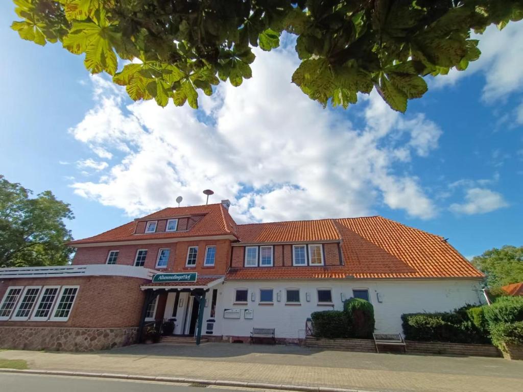 a building with an orange roof on a street at Altenmedinger Hof in Altenmedingen