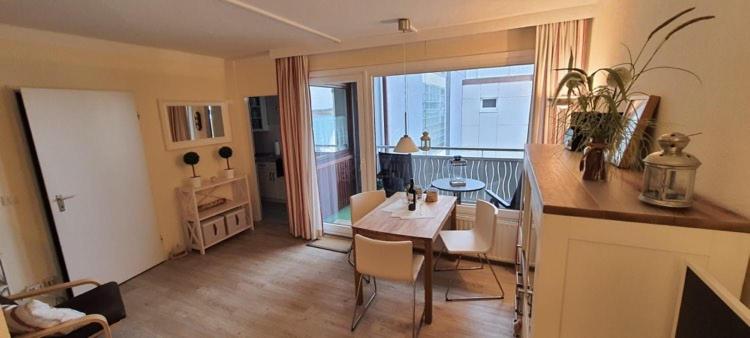 a kitchen and dining room with a table and chairs at Ferienhaus Christianenhöhe App 34 in Westerland (Sylt)