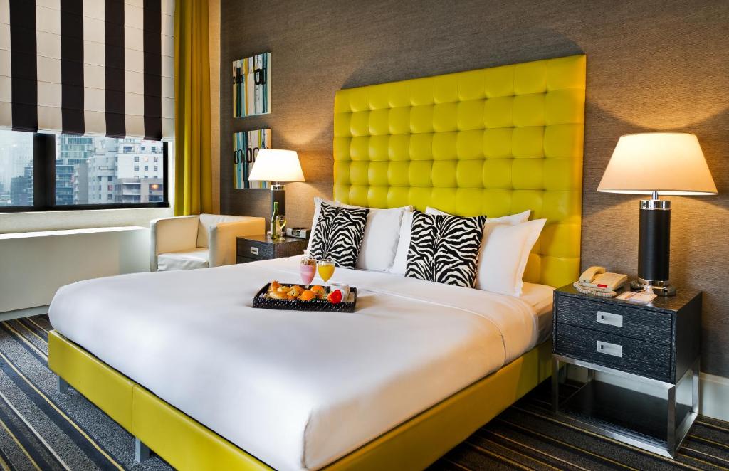 a hotel room with a bed and a lamp at The Marcel at Gramercy in New York