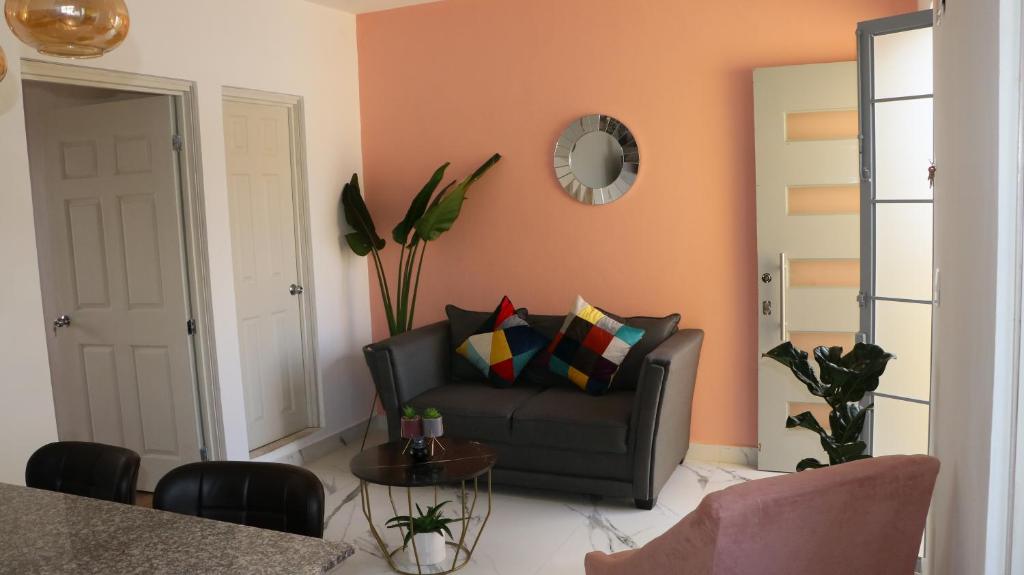 a living room with a couch and a table at LA CASA AMARILLA, centrica, barrio local. in Comitán de Domínguez