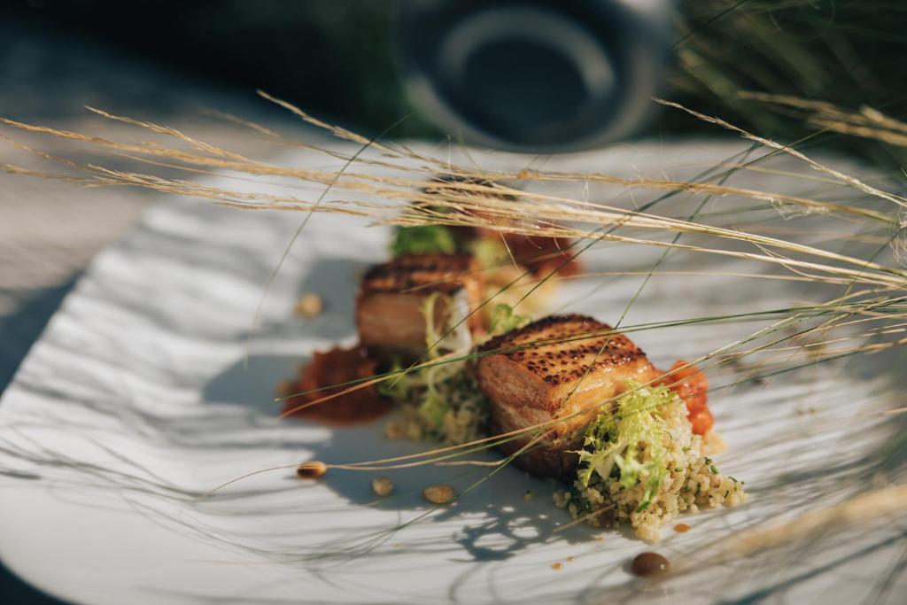 two pieces of food on a white plate at Crowne Plaza Limassol by IHG in Limassol