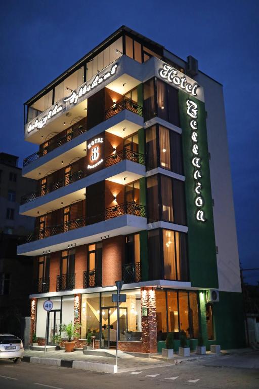 a building with a sign on the side of it at Bessarion Boutique Hotel in Kutaisi