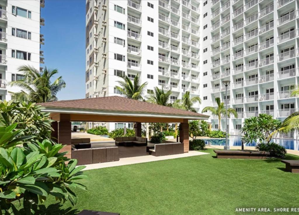 a gazebo in front of a large apartment building at NJ's Place, Shore 1 Residences, MOA Complex, Pasay City, Philippines in Manila