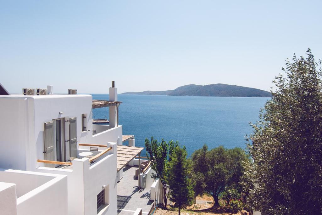 a white building with a view of the water at Vassiliki Residence Skyros Island in Skiros