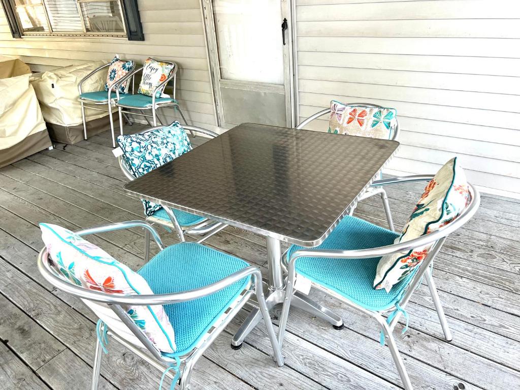 a table and chairs sitting on a porch at White Caps Motel in Port Clinton