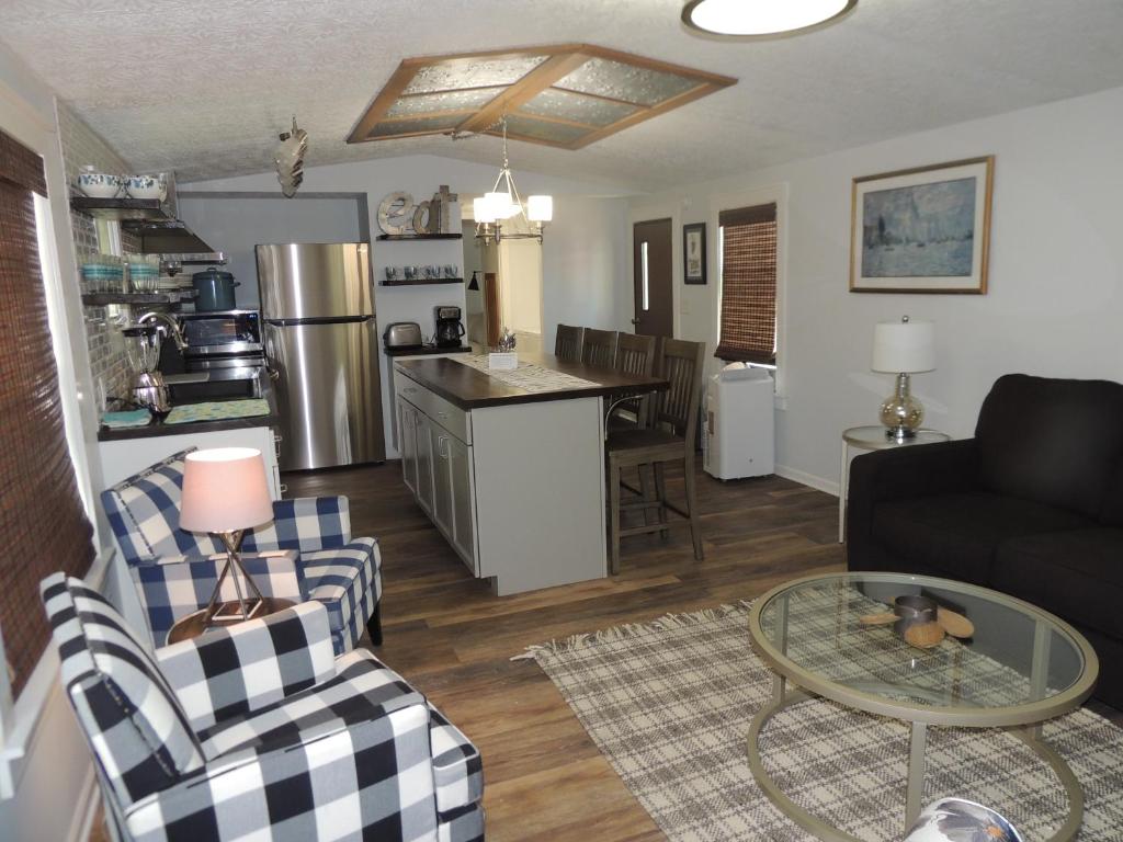 a living room and kitchen with a couch and a table at White Caps Motel in Port Clinton