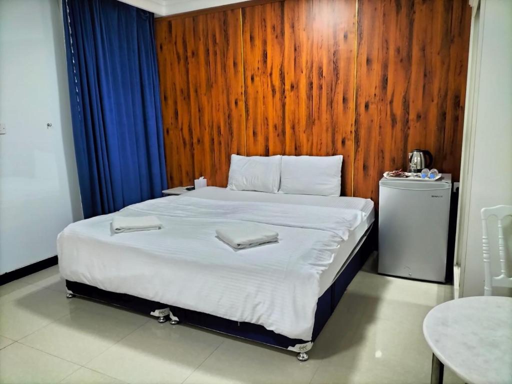 Krevet ili kreveti u jedinici u okviru objekta Al Rayyan Hotel Apartments Muscat
