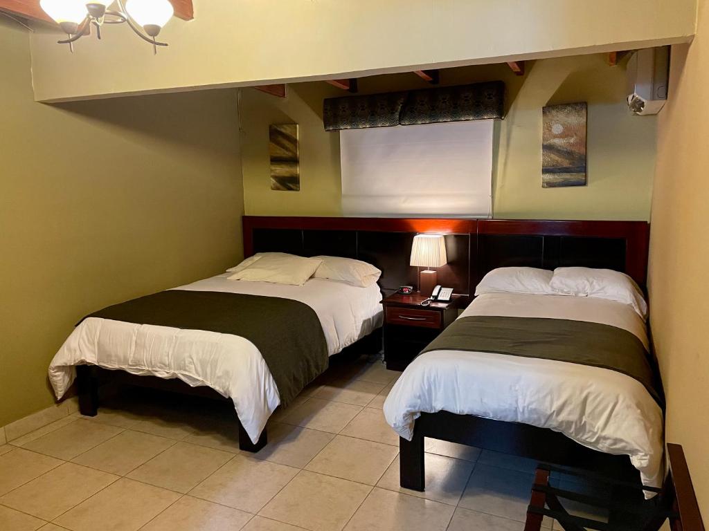 Postel nebo postele na pokoji v ubytování Sofia's B&B Hostal Boutique