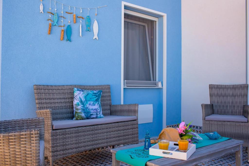 a living room with two chairs and a table at Vittoria Luxury Rooms in Sciacca