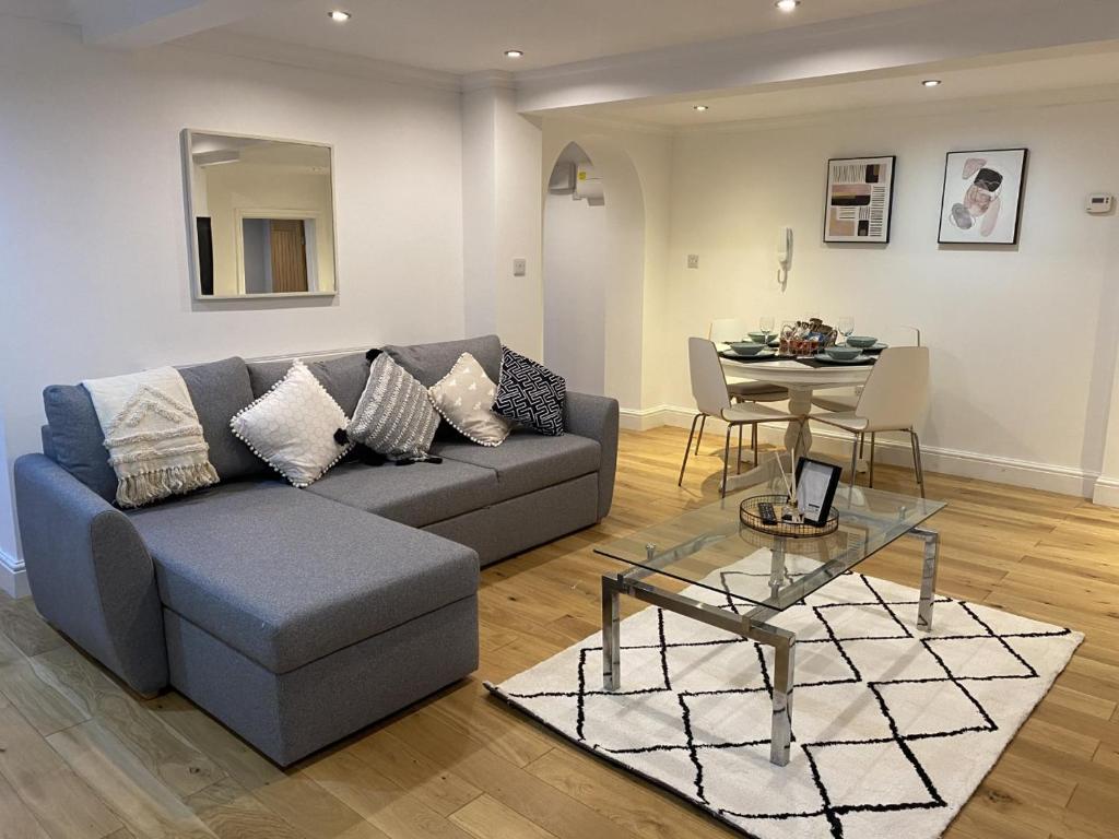 a living room with a couch and a table at Modern & Spacious Leeds City Centre Apartment with Parking - Sleeps 5 in Leeds