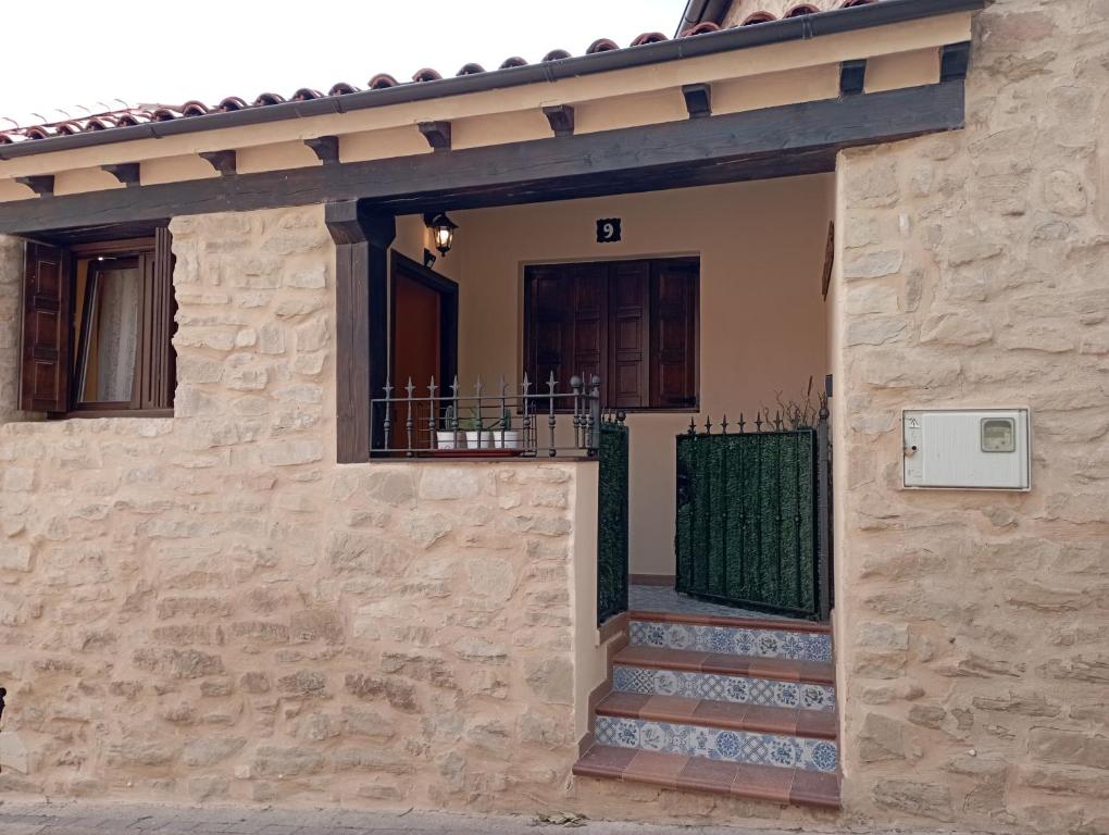 a stone house with a gate and a staircase at Inma Enea in Armañanzas