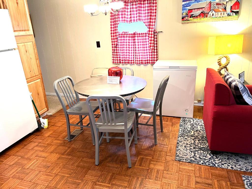 a kitchen with a table and chairs and a refrigerator at White Caps Motel in Port Clinton