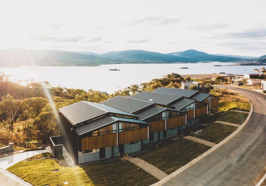 an aerial view of a building with a lake in the background at Kunama Townhouses in Jindabyne