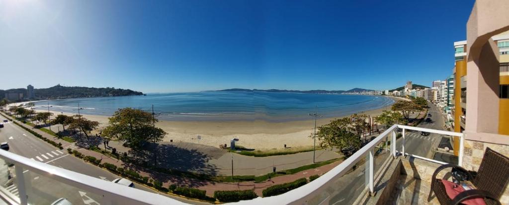 a view of a beach and the ocean from a balcony at Apartamento de Cobertura frente para o mar Itapema in Itapema