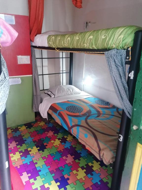 Postel nebo postele na pokoji v ubytování Hostal Gastro Bar Casa Colibrí