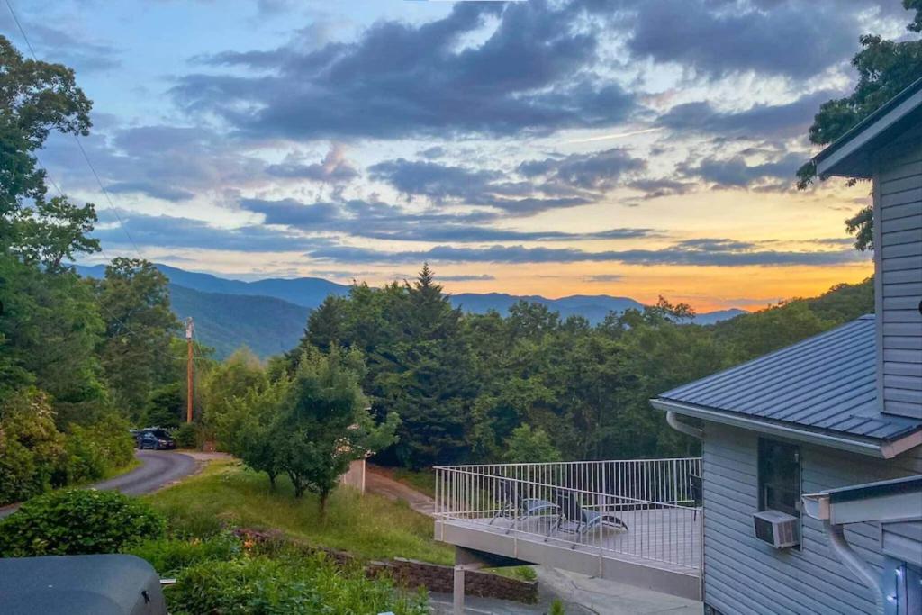 a house with a balcony with a view of the mountains at Roamer's Respite - A Prime Location with Scenic Views For Your Ultimate Retreat in Sylva