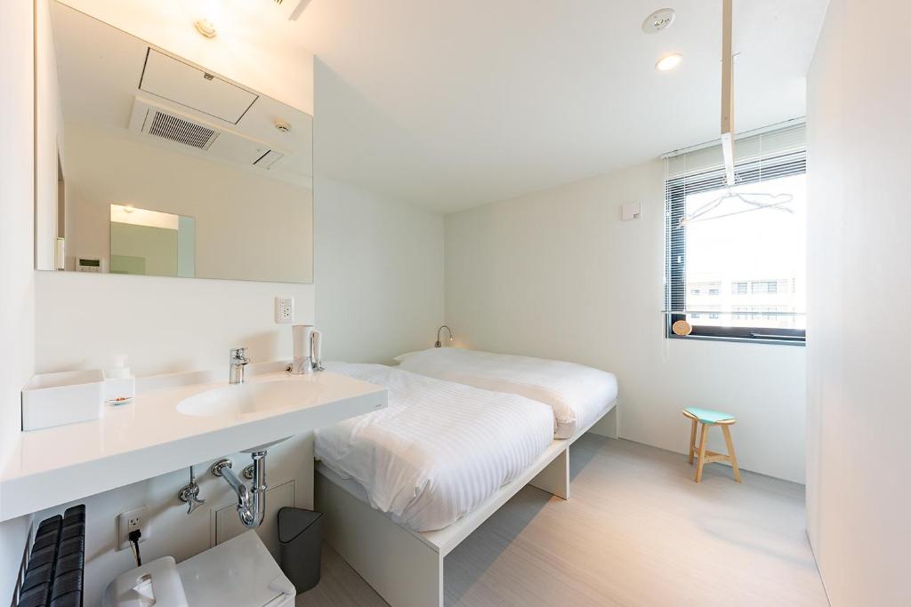 Postel nebo postele na pokoji v ubytování plat hostel keikyu sapporo ichiba