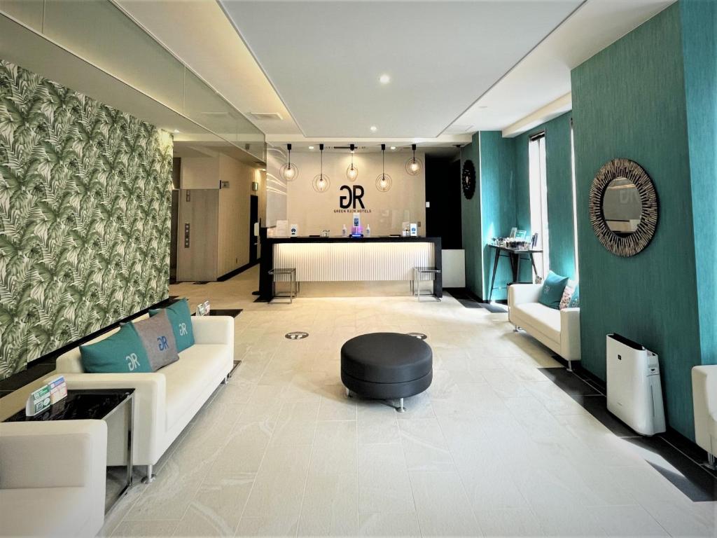 a living room with a couch and a table at Green Rich Hotel & Capsule Naha - Artificial hot spring Futamata Yunohana in Naha