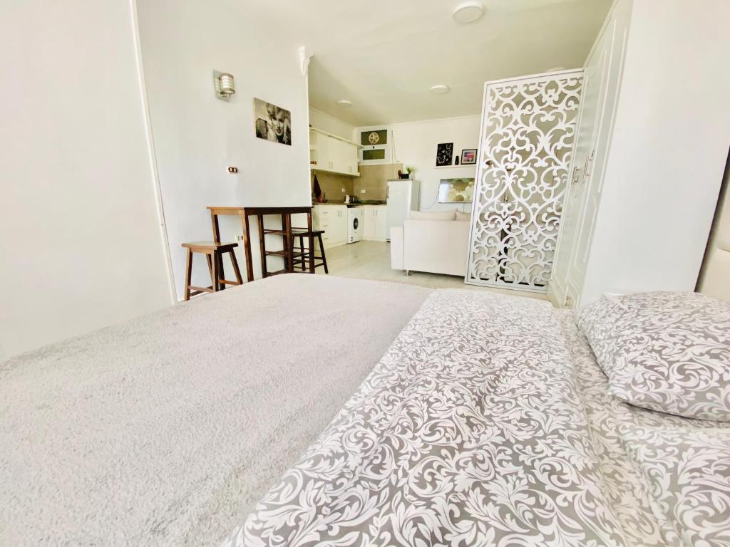 a bedroom with a large bed and a kitchen at Marilyn Studio with Sea View Wi Fi in Hurghada